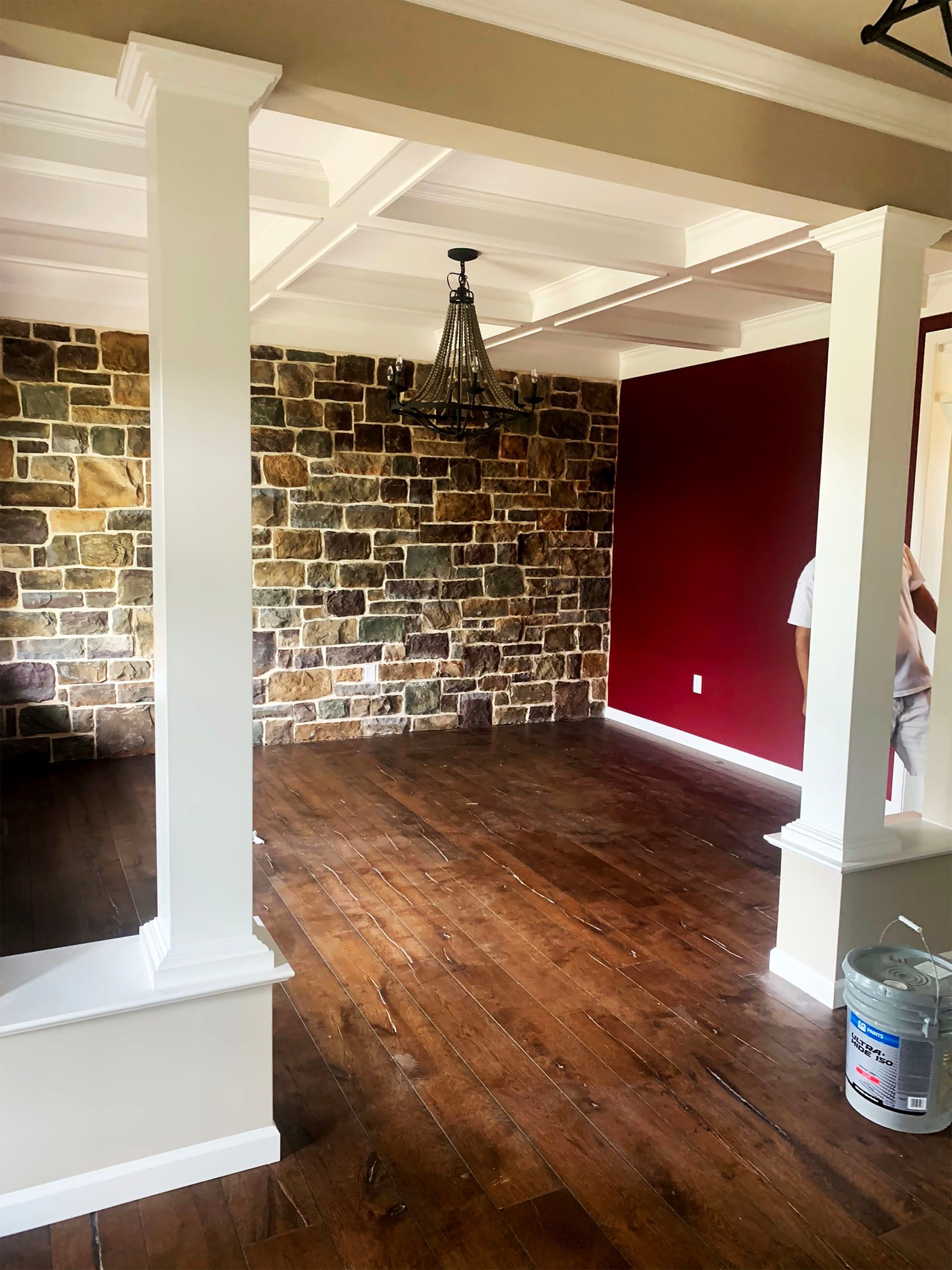 Red walls with a painted brick wall and gloss ceiling